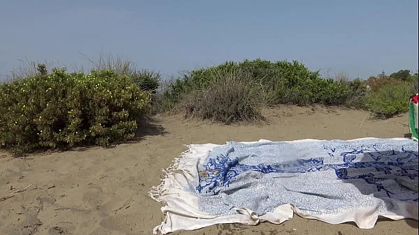 Hot brunette milf masturbating and squirting on public beach